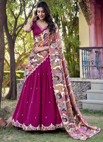 Mesmerizing Rani color Vichitra SIlk lehenga choli with sequin embroidery and kalamkari border.